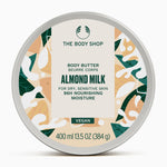 A round container of The Body Shop Almond Milk Body Butter 400ml against a clean, uniform background