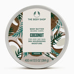 The Body Shop Coconut Body Butter 400ml on white marble surface, showcasing tropical design and moisturizing properties