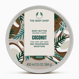 The Body Shop Coconut Body Butter 400ml on white marble surface, showcasing tropical design and moisturizing properties