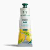 Tube of The Body Shop Mango Hand Balm 30ml with vibrant design highlighting its vegan properties on plain background