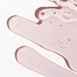 Close-up of Pink Grapefruit Shower Gel 250ml showcasing its smooth texture against a blurred background.