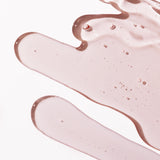 Close-up of Pink Grapefruit Shower Gel 250ml showcasing its smooth texture against a blurred background.