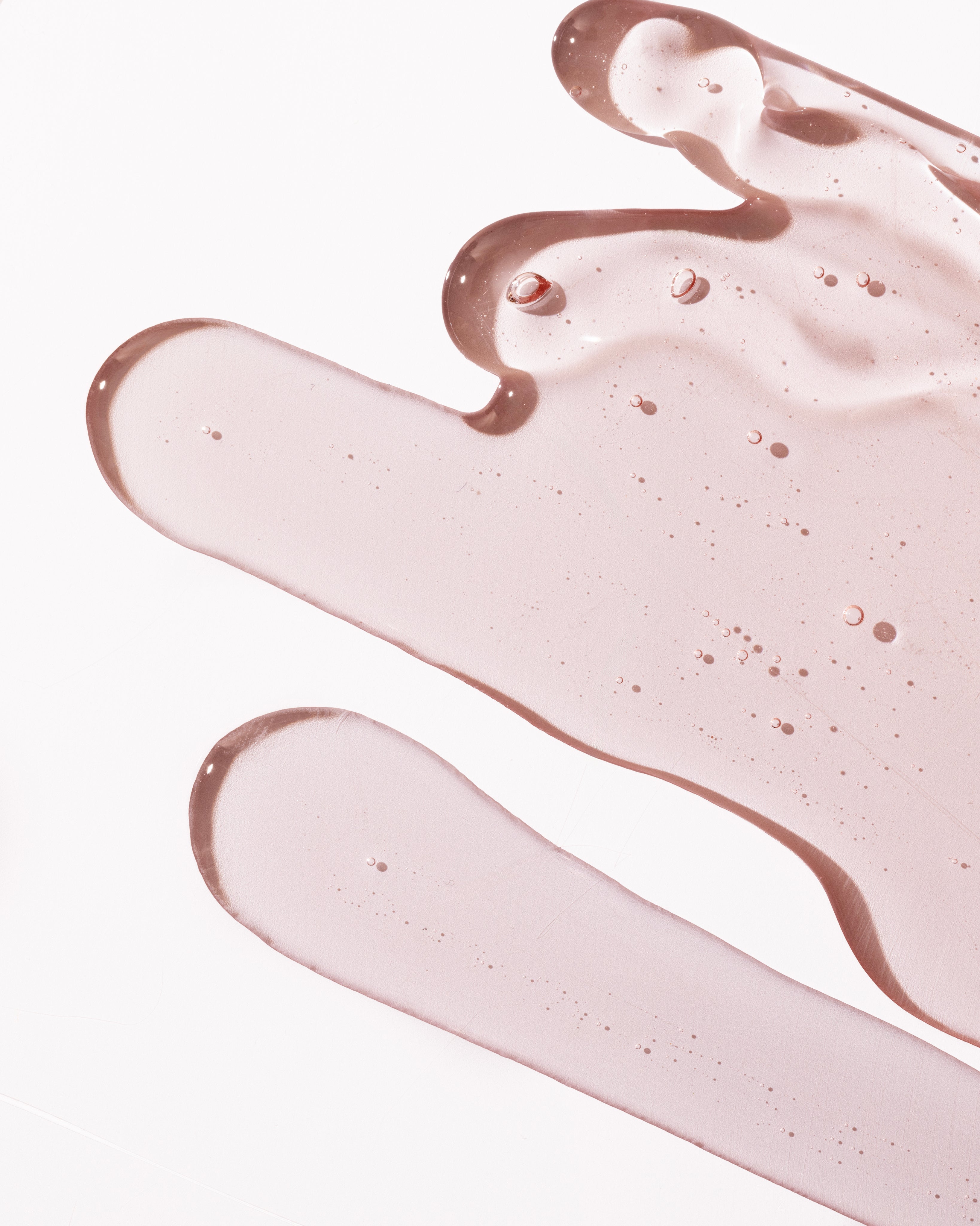 Close-up of Pink Grapefruit Shower Gel 250ml showcasing its smooth texture against a blurred background.