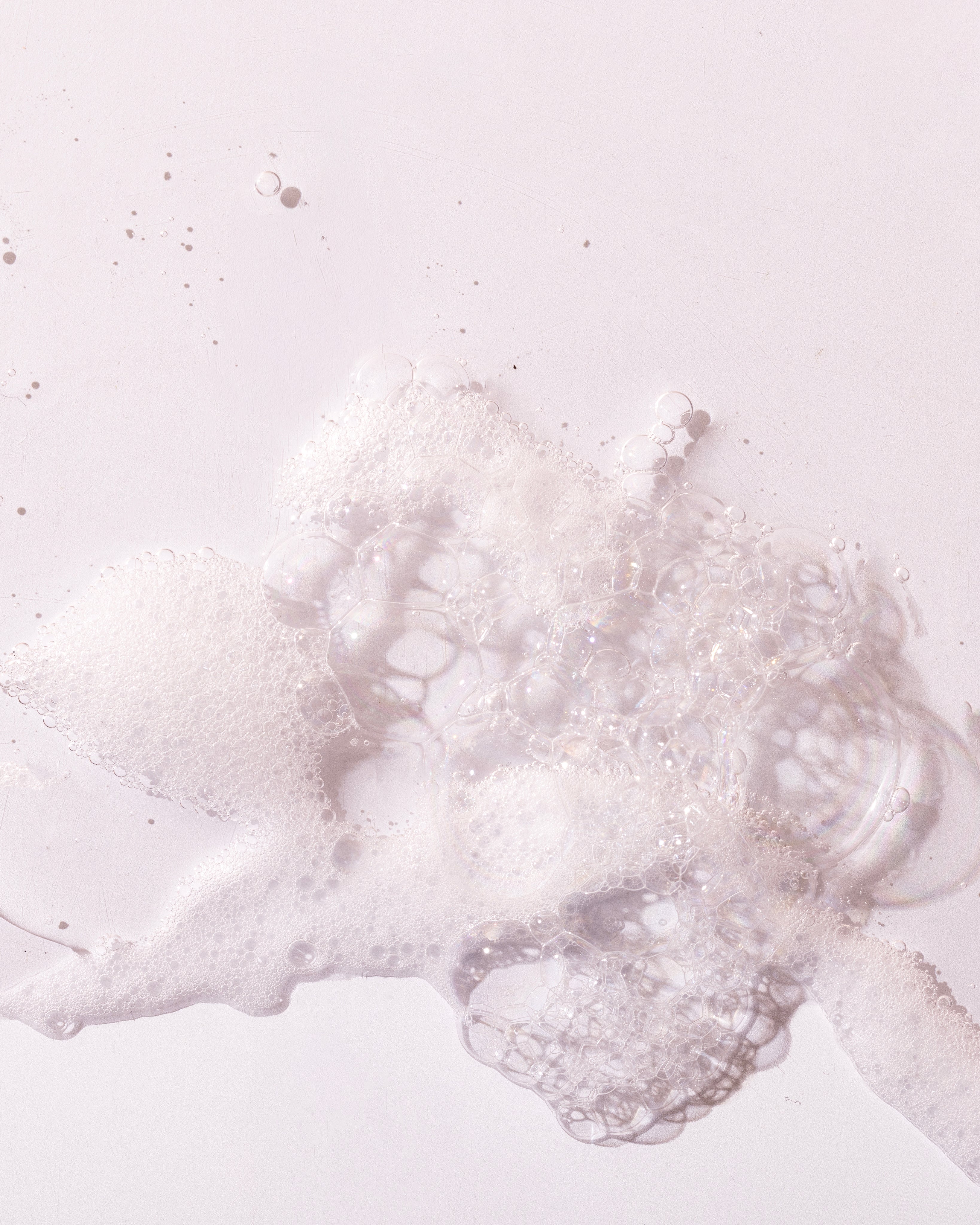 Close-up of bubbles from British Rose Shower Gel 250 ML on clean white surface