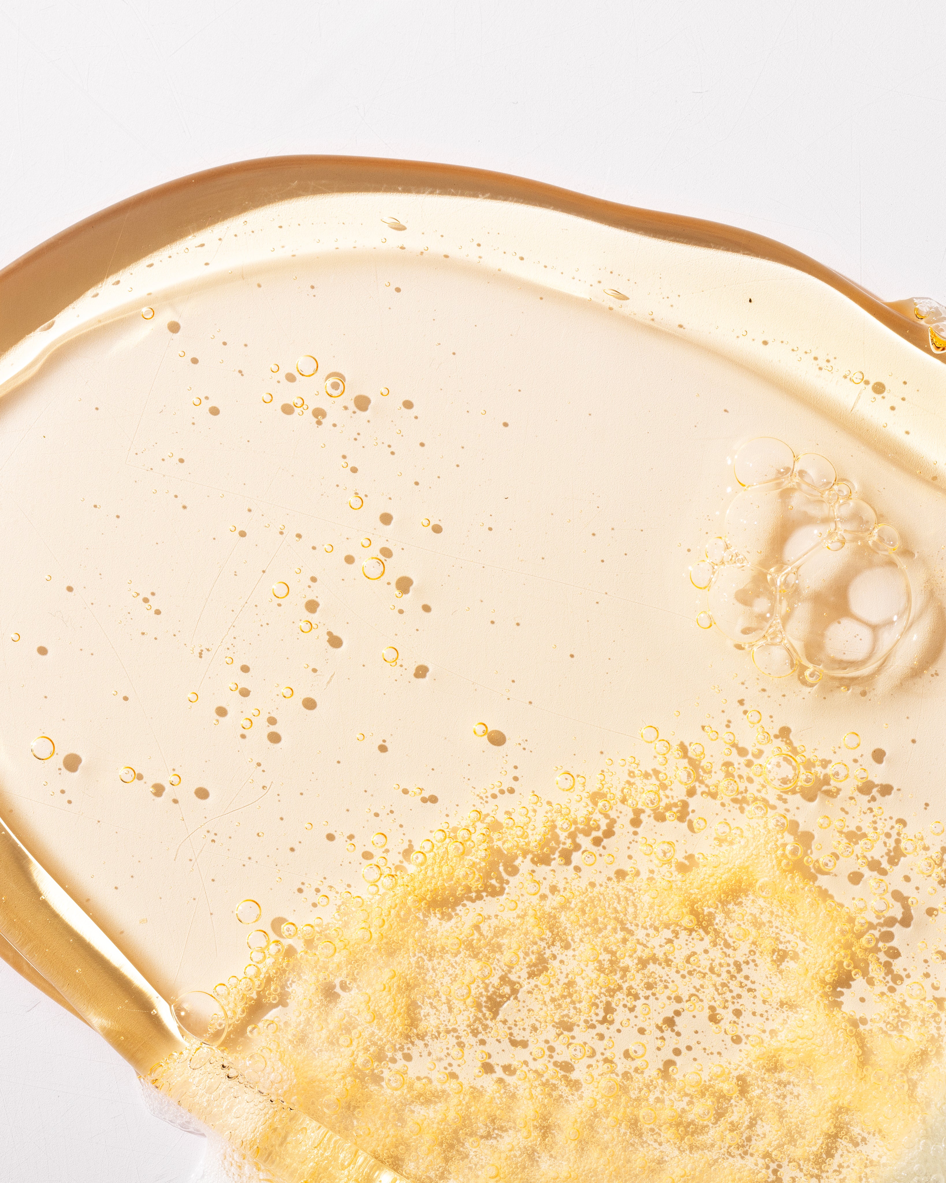 Close-up of Mango Shower Gel 250ml showcasing bubbly texture on clean surface
