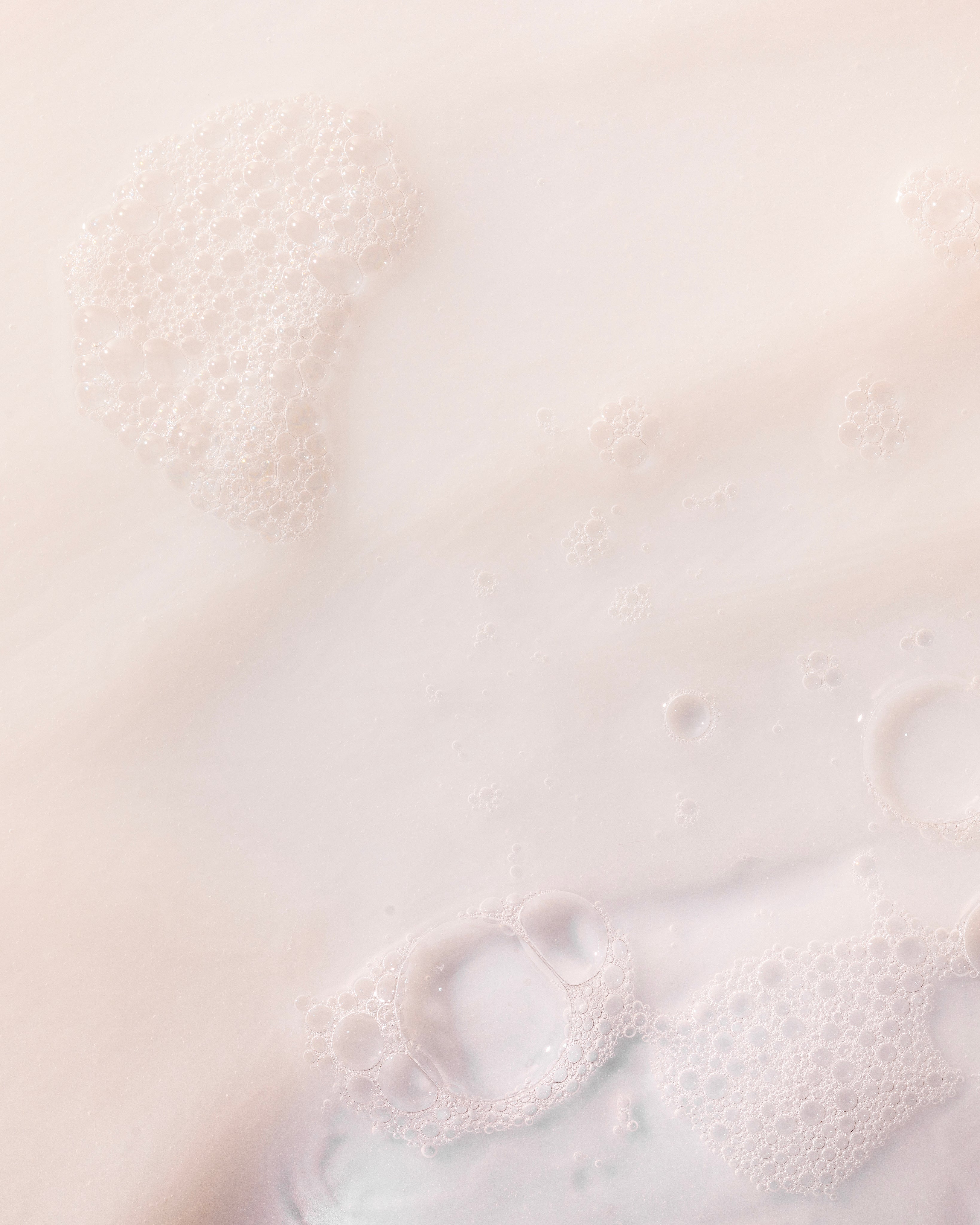 Creamy Coconut Shower Cream 250 ML against a soft light background, showcasing bubbles and a smooth texture.