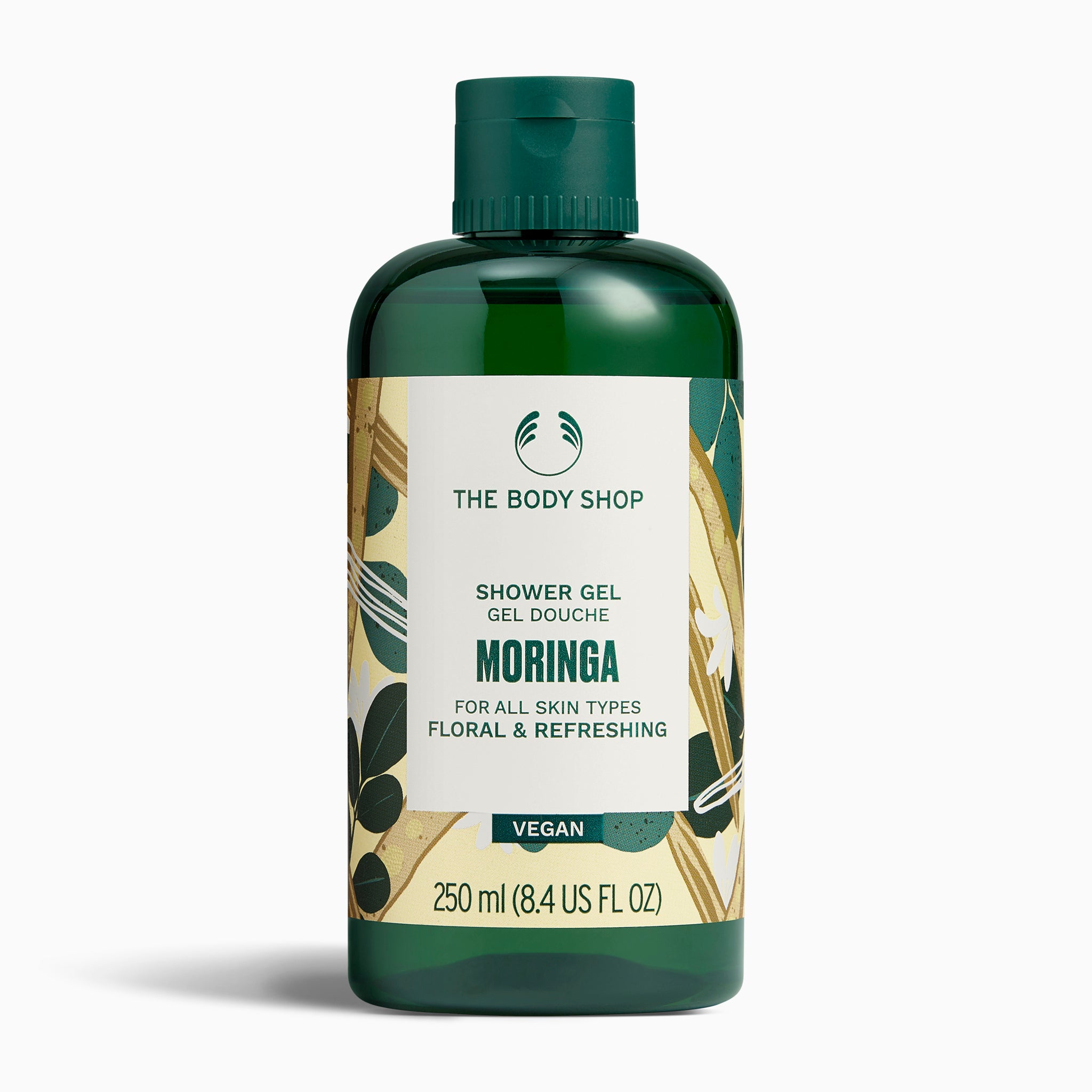 The Body Shop Moringa Shower Gel 250 ML featuring floral packaging on studio backdrop