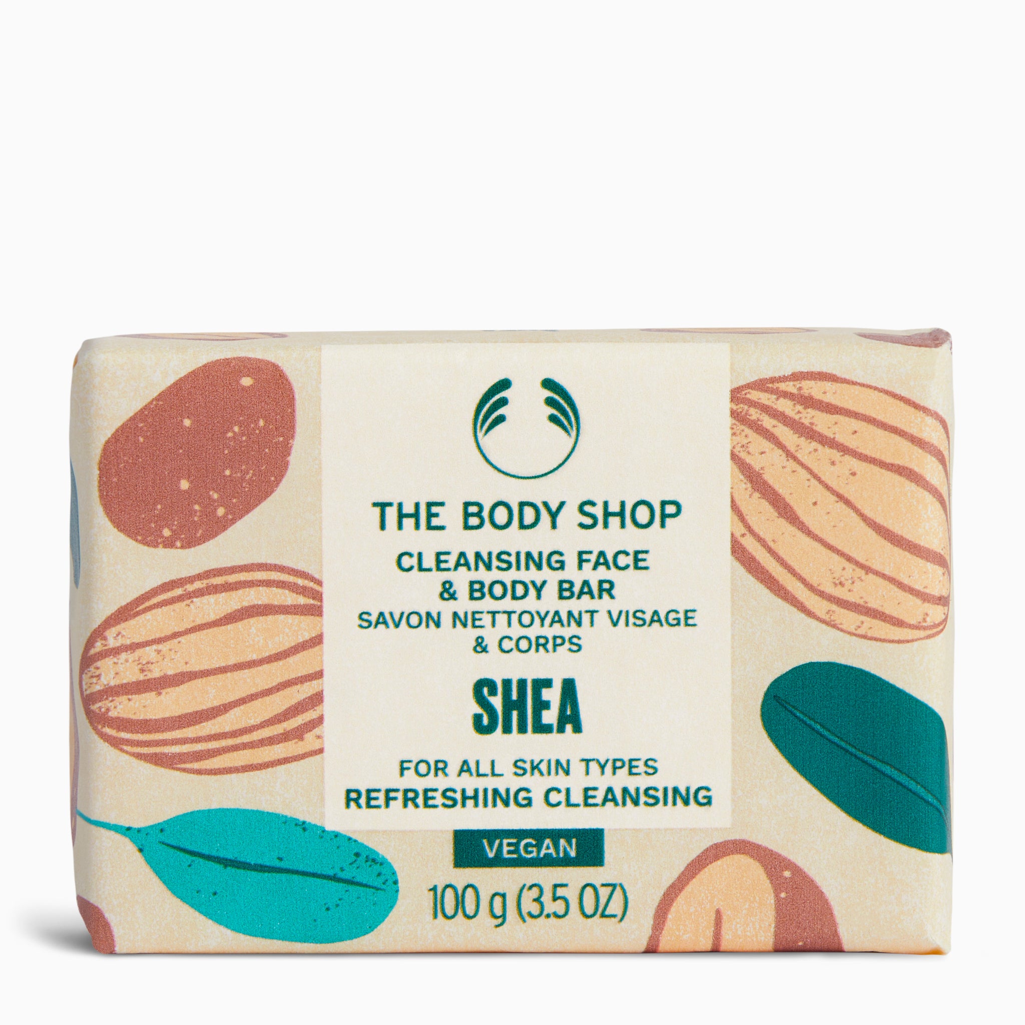 The Body Shop Cleansing Face & Body Bar 100g against colorful patterned packaging