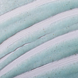 Close-up of Peppermint Reviving Pumice Foot Scrub 100ML showcasing creamy texture against a plain backdrop.
