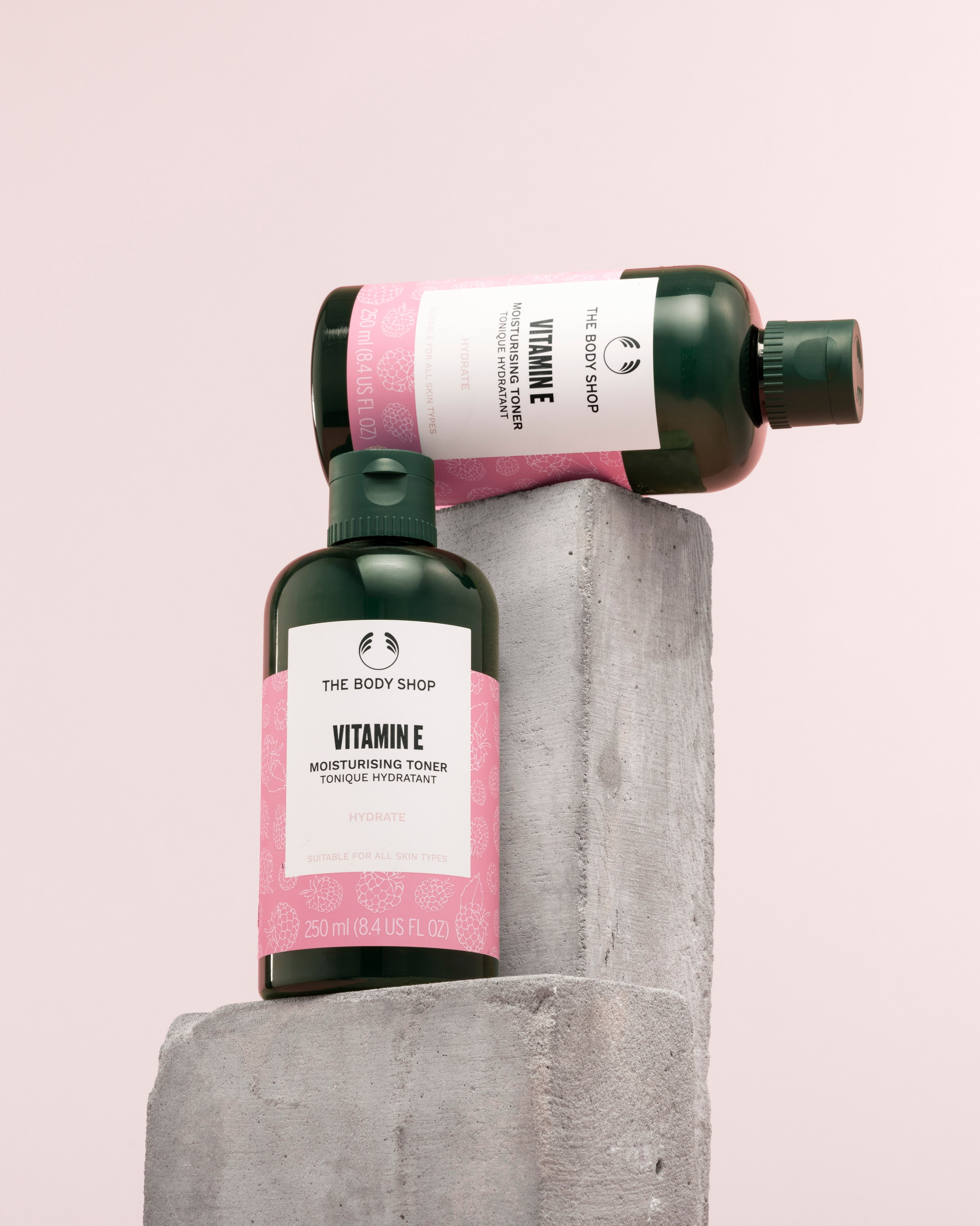 Visually appealing arrangement of The Body Shop Vitamin E Moisturising Toner 250 ML against soft pink background