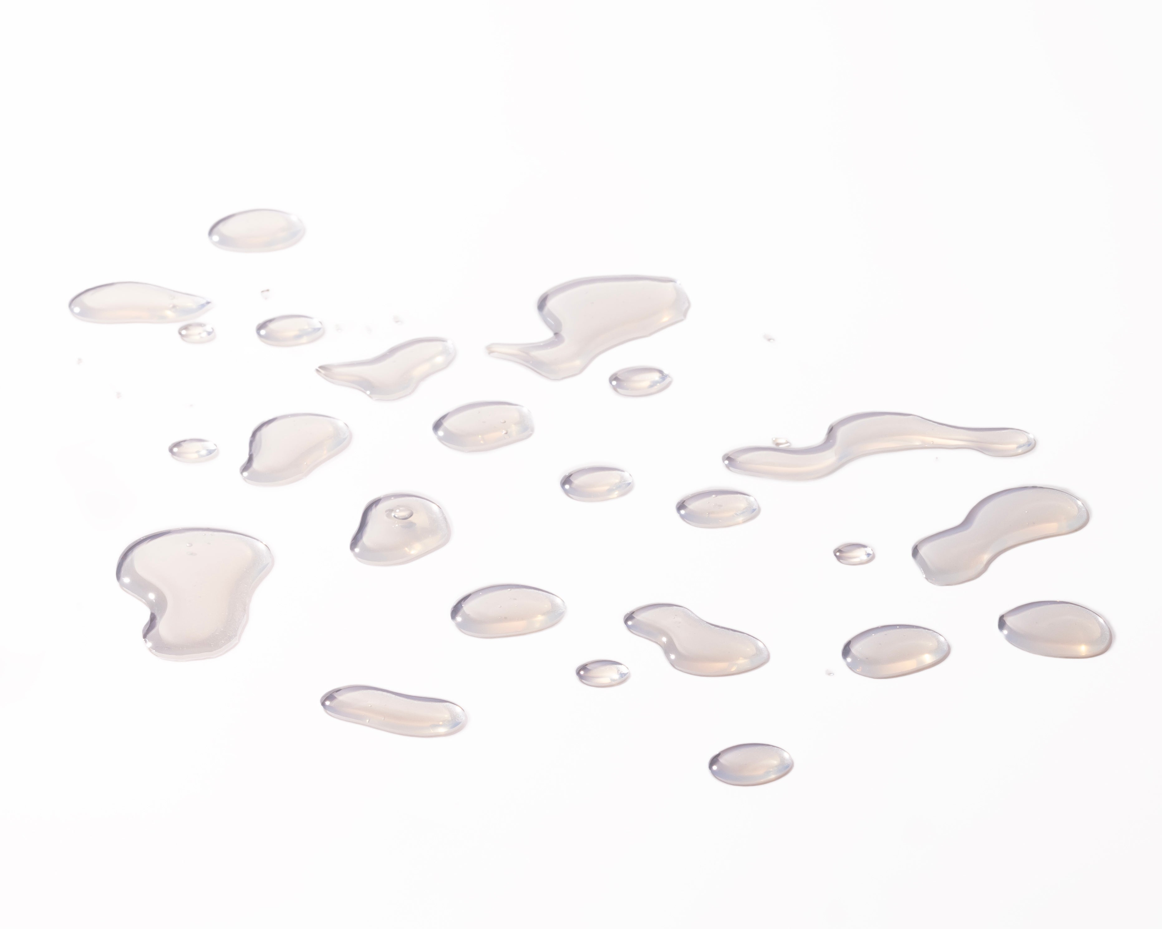 Close-up of liquid droplets resembling Vitamin E Moisturising Toner 250 ML against a soft background.