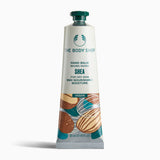 The Body Shop Shea Hand Balm 30 ML for dry skin, featuring nourishing moisture, displayed on a clean background.