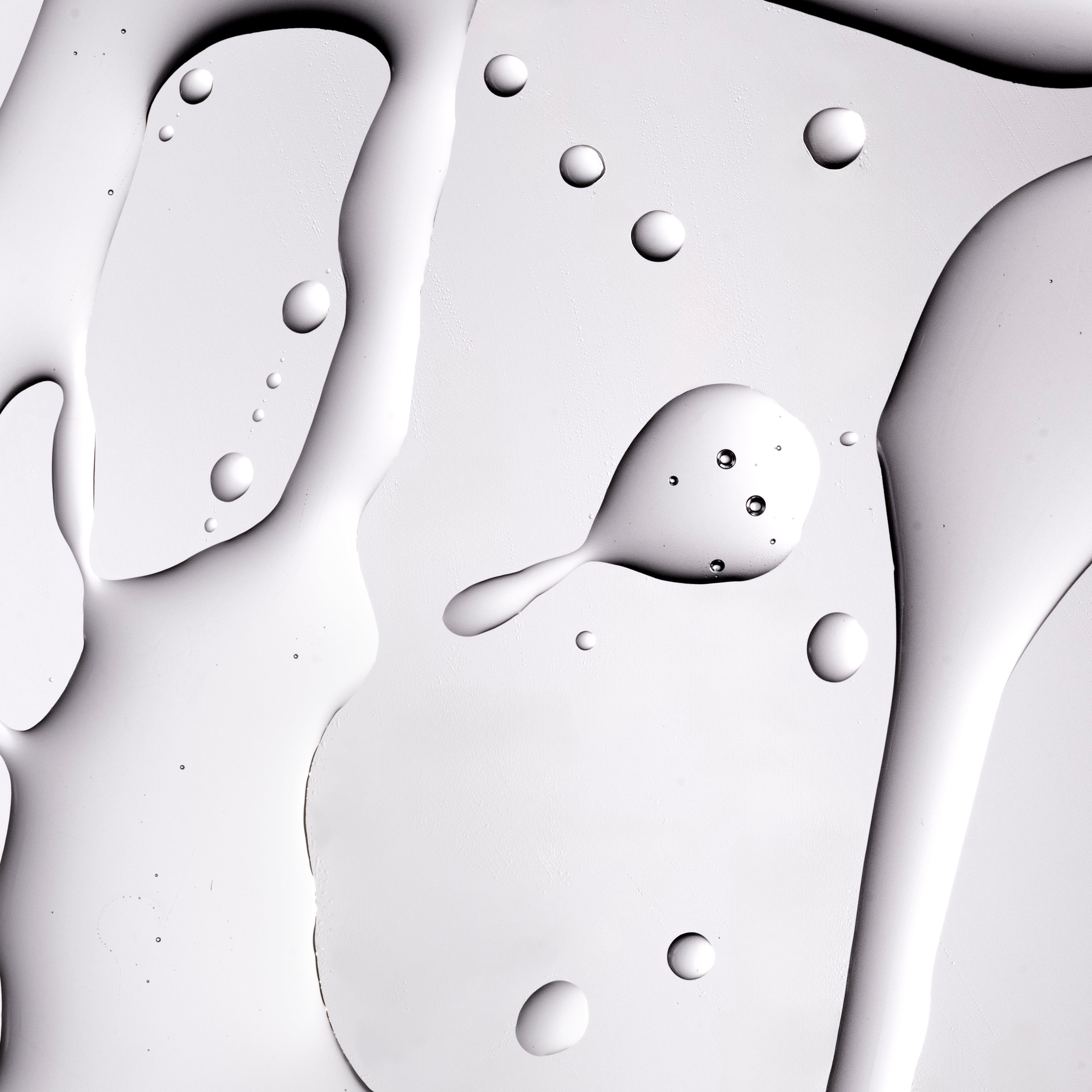 Close-up image showcasing smooth gel texture with droplets, reflecting light on studio backdrop