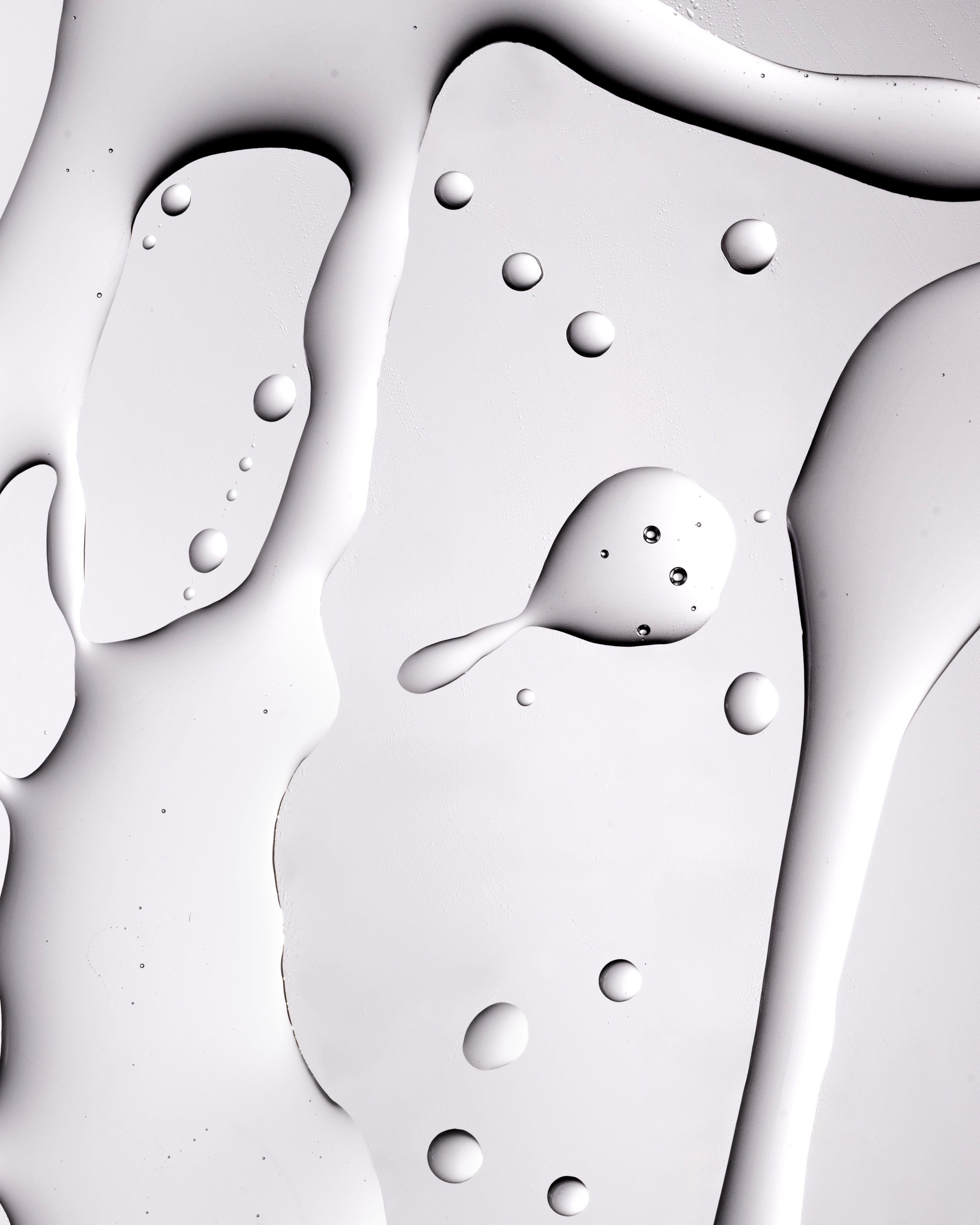 Close-up image showcasing smooth gel texture with droplets, reflecting light on studio backdrop