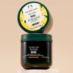 The Body Shop Mango Body Yogurt 200 ML elegantly displayed on a textured surface with a minimalist backdrop.