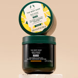 The Body Shop Mango Body Yogurt 200 ML elegantly displayed on a textured surface with a minimalist backdrop.