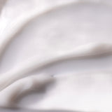 Close-up of creamy body yogurt demonstrating smooth texture, ideal for skin application.