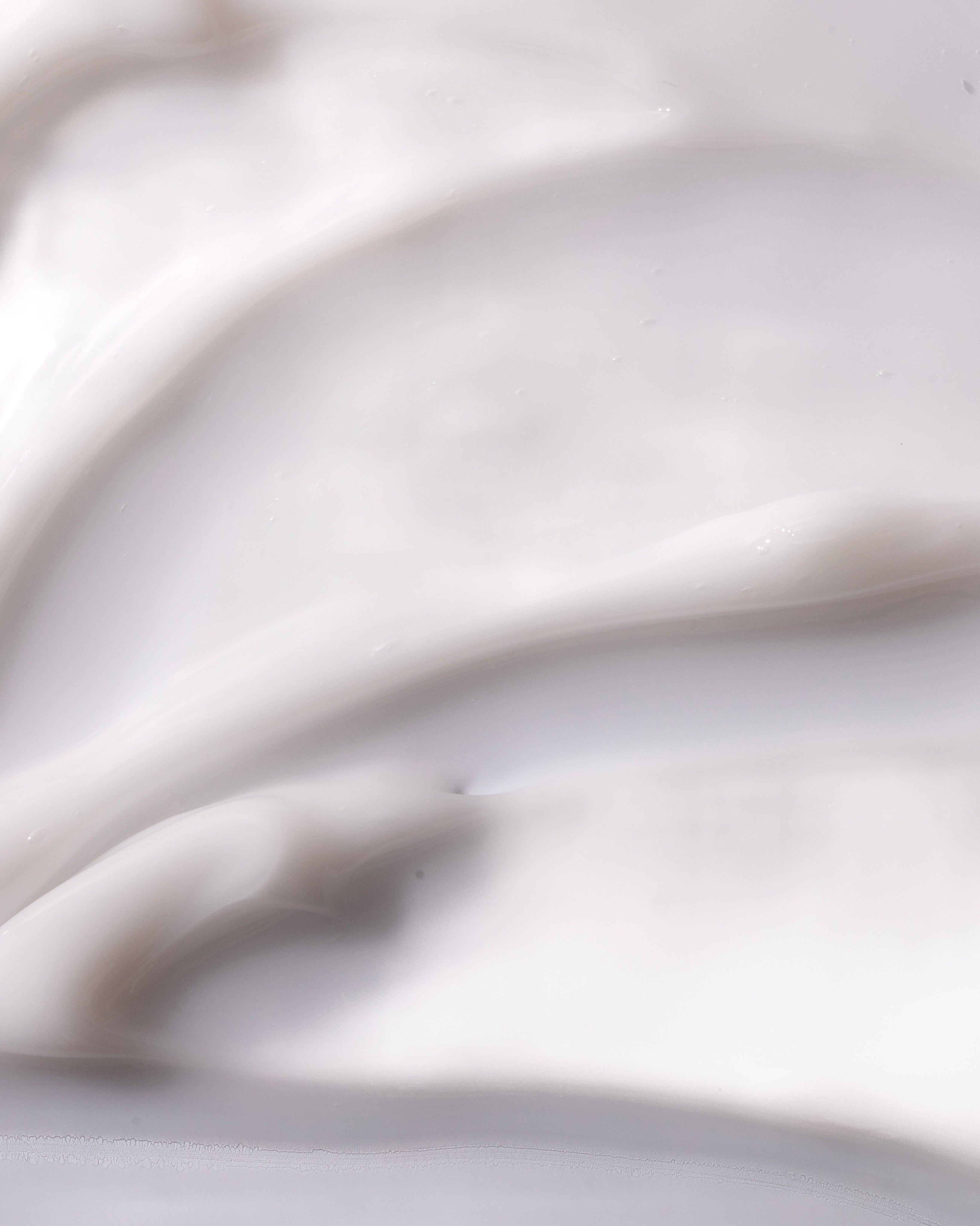 Close-up of creamy body yogurt demonstrating smooth texture, ideal for skin application.