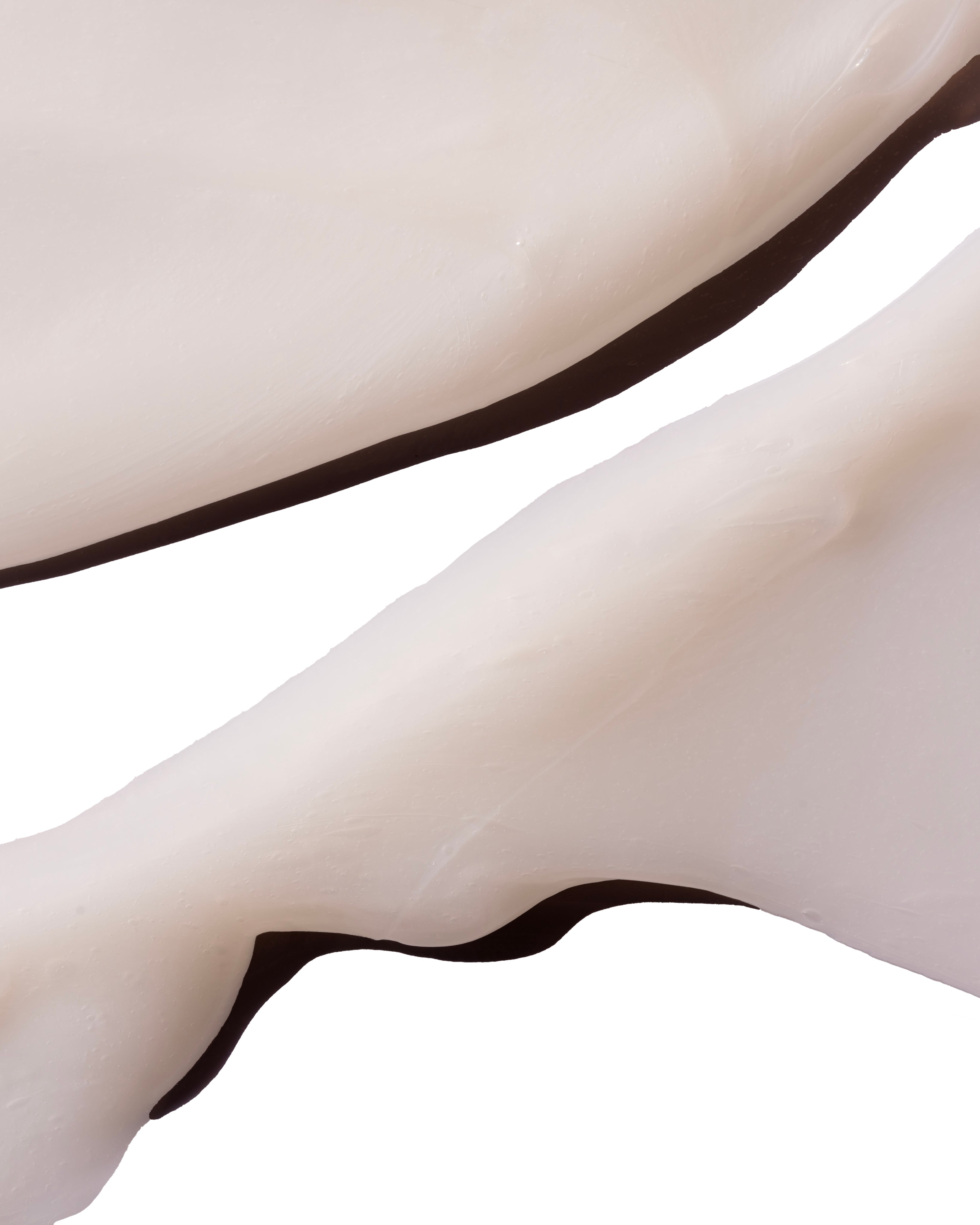 Close-up of Ginger Scalp Care Conditioner 250 ML, showcasing creamy texture against a soft background.