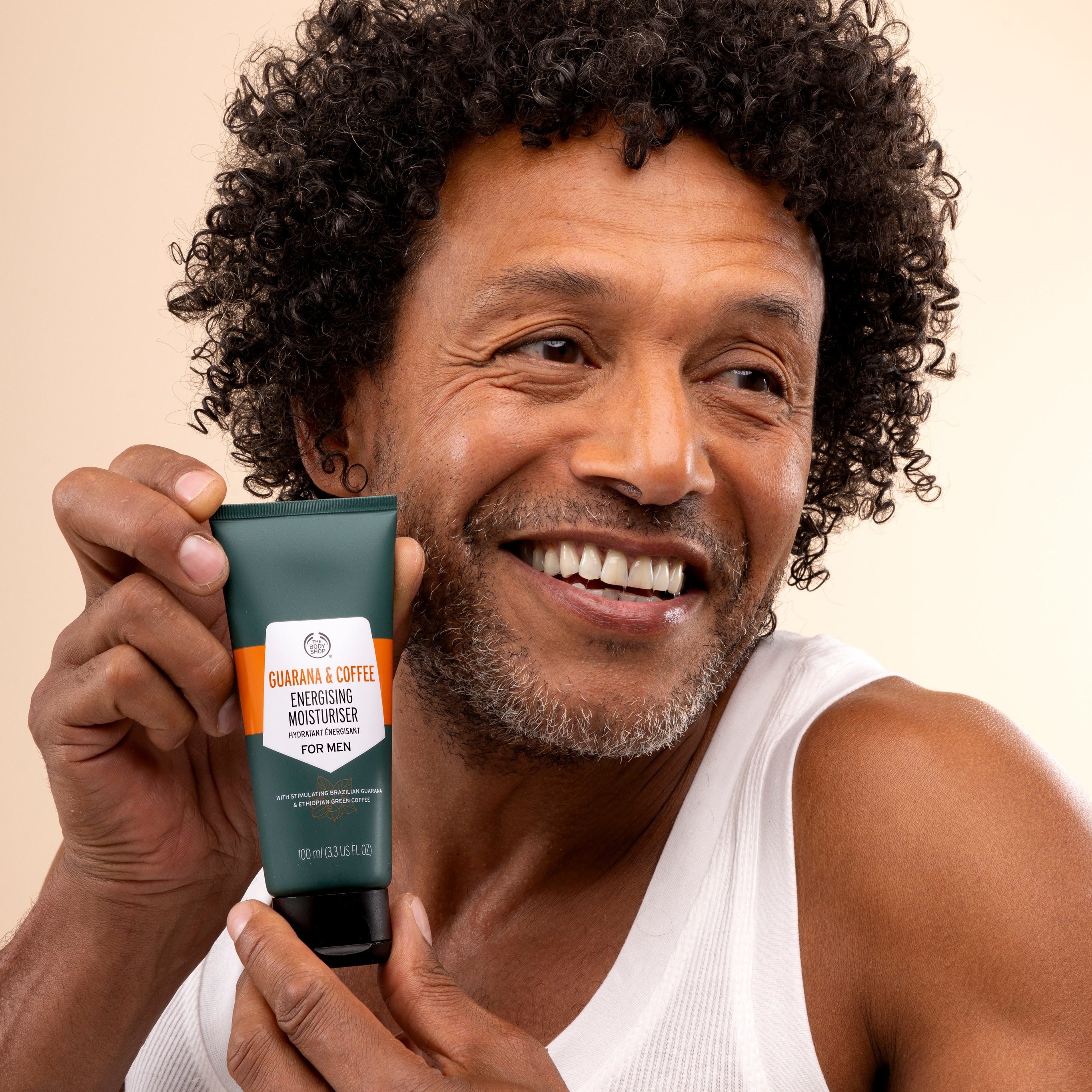 Man displaying Guarana & Coffee Energising Moisturiser For Men 100 ML against neutral background