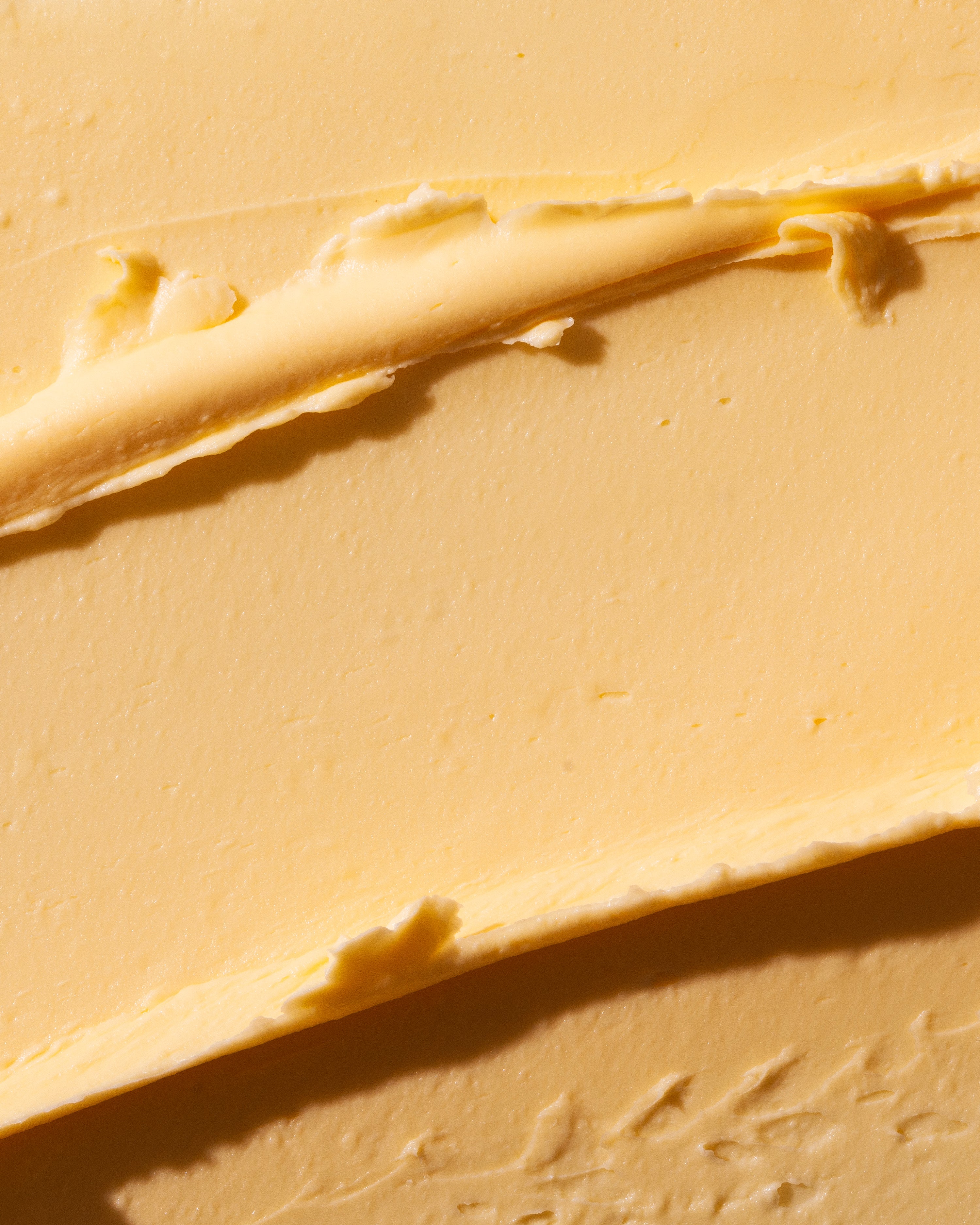 Close-up view of creamy mango body butter 200ml showcasing its rich texture against a soft background