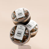 Three jars of The Body Shop Coconut Body Butter 200ml arranged on a clean surface, showcasing vibrant packaging.