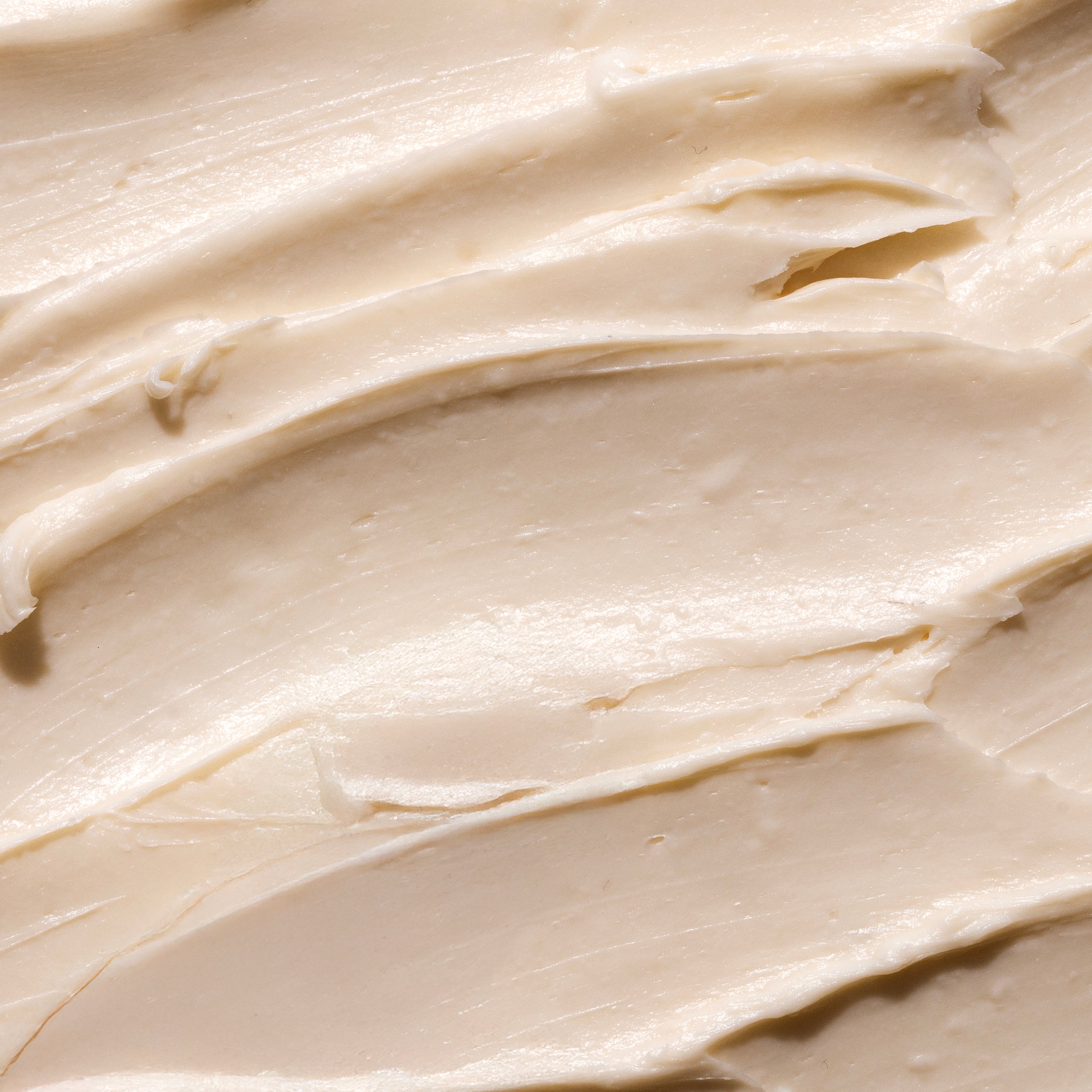 Close-up of creamy Shea Body Butter, showcasing its smooth texture