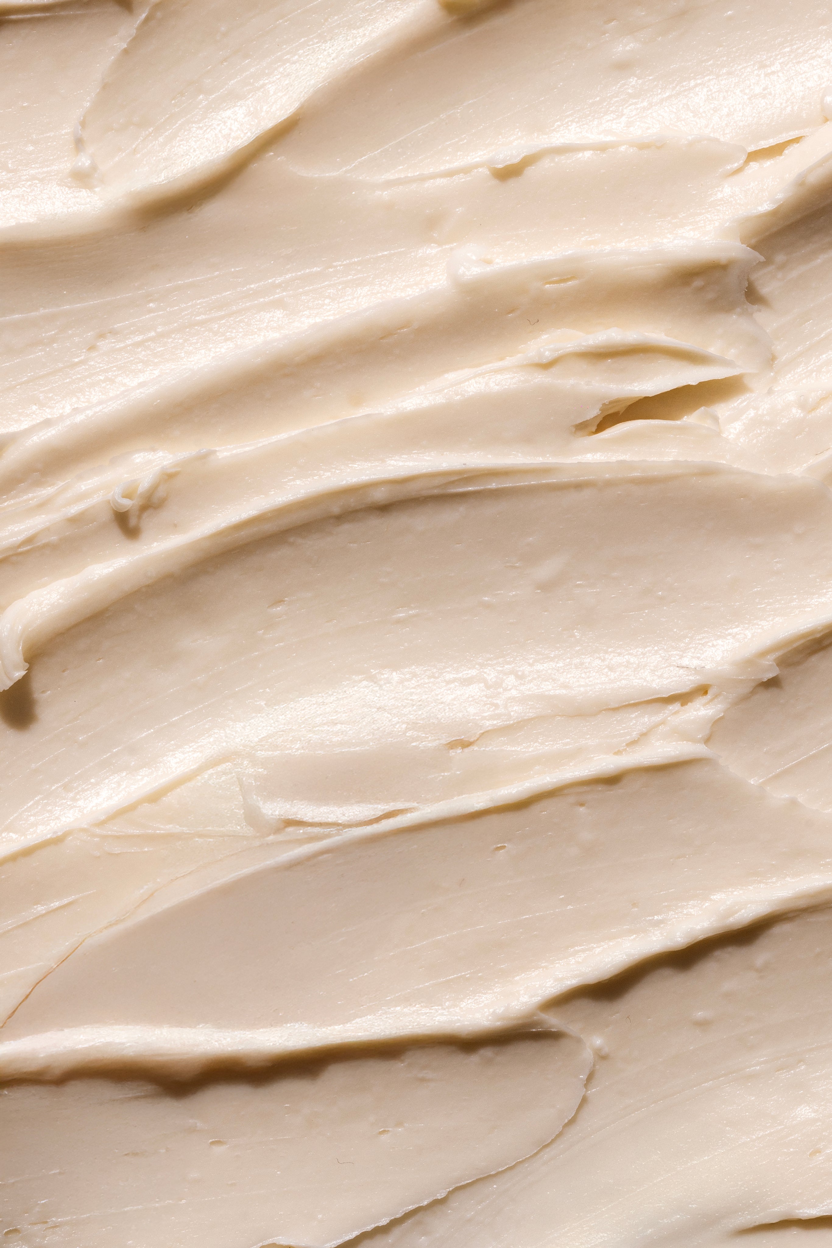 Close-up of creamy Shea Body Butter, showcasing its smooth texture