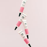 Arrangement of The Body Shop Vitamin E Eye Cream 15 ML against soft pink background