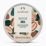 A jar of The Body Shop Shea Body Butter 400 ML with vibrant natural-themed label against soft background