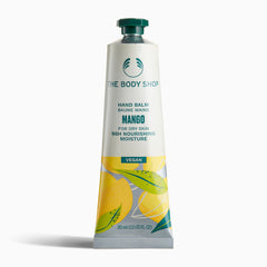 Tube of The Body Shop Mango Hand Balm 30ml with vibrant design highlighting its vegan properties on plain background