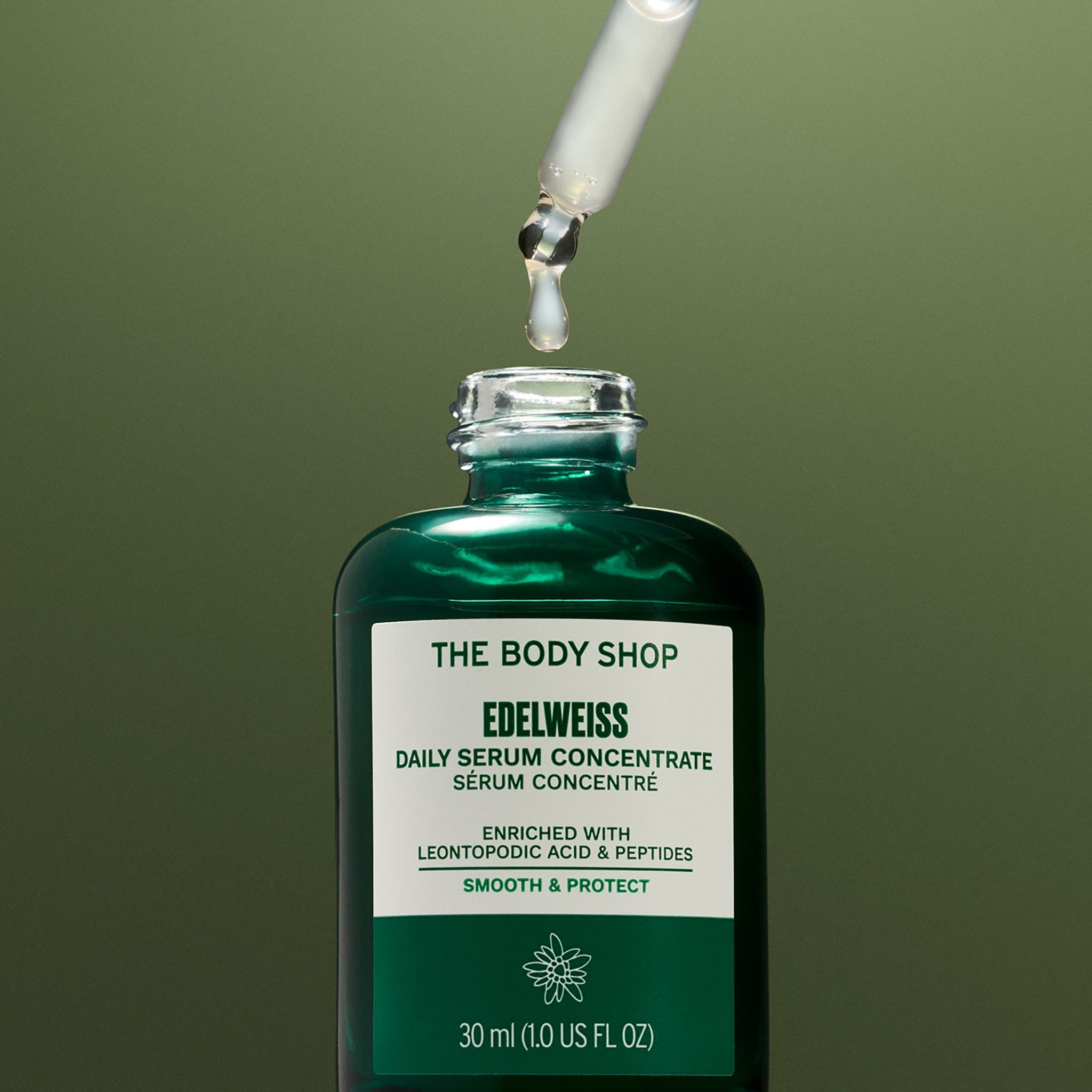 Edelweiss Serum with dropper on green background
