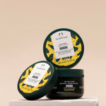 Three jars of The Body Shop Banana Truly Nourishing Hair Mask 240 ML displayed with a neutral background.
