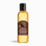 Bottle of The Body Shop Coconut Oil 200ml against white background for nourishing hair before shampooing.