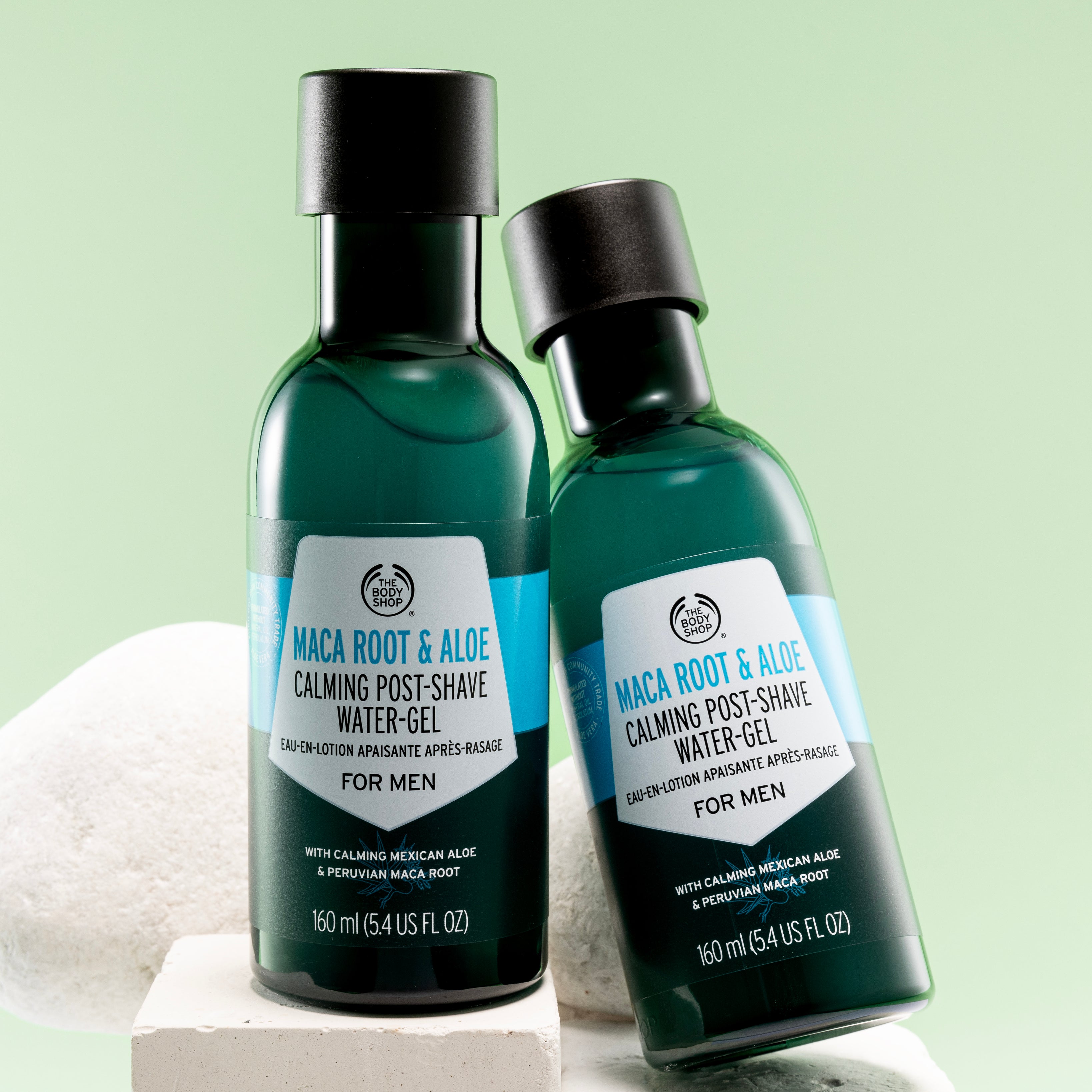 Pair of The Body Shop Maca Root & Aloe Calming Post-Shave Water Gel For Men 160 ML against light green background