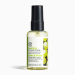 The Body Shop Grapeseed Glossing Serum 60ml on a clean surface, designed to smooth dull frizzy hair.