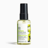 The Body Shop Grapeseed Glossing Serum 60ml on a clean surface, designed to smooth dull frizzy hair.