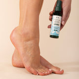 Person holding The Body Shop Peppermint Invigorating Foot & Leg Mist 100 ML against a soft neutral background