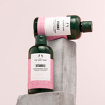 Visually appealing arrangement of The Body Shop Vitamin E Moisturising Toner 250 ML against soft pink background