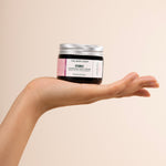 Person holding The Body Shop Vitamin E Nourishing Night Cream 50 ML against soft beige background