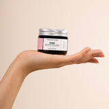 Person holding The Body Shop Vitamin E Nourishing Night Cream 50 ML against soft beige background