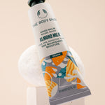 The Body Shop Almond Milk Hand Balm 30 ML on a stylish studio backdrop, showcasing nourishing properties.