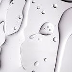 A close up shot of The Body Shop Tea Tree Oil texture on a grey background