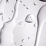 A close up shot of The Body Shop Tea Tree Oil texture on a grey background