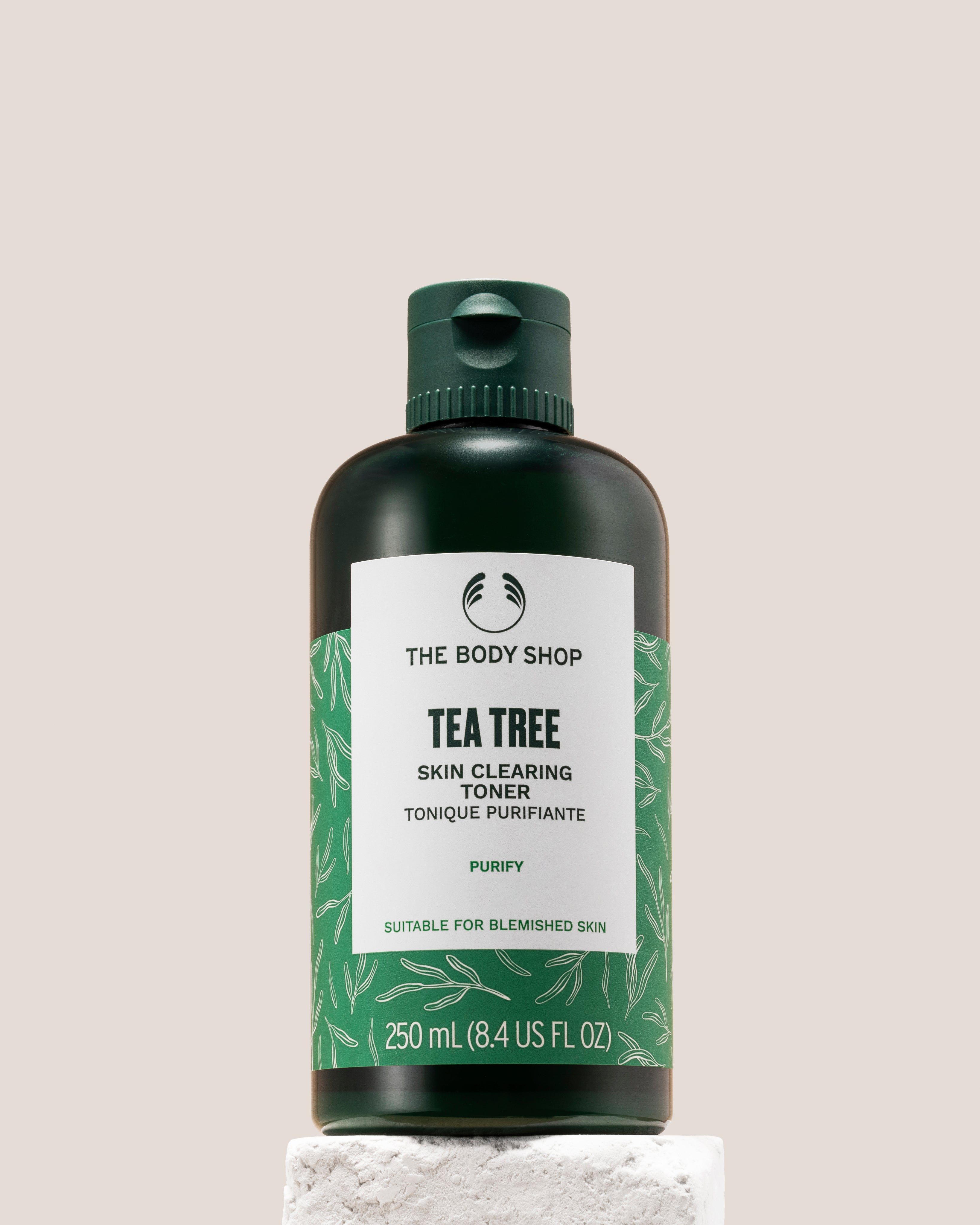 The Body Shop Tea Tree Skin Clearing Toner 250ml displayed on a clean pedestal against a soft background