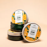 Three Satsuma Body Butter containers 200 ML from The Body Shop stacked against soft peach background.