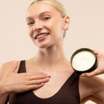 Woman applying Satsuma Body Butter 200 ML in professional studio setup against soft backdrop