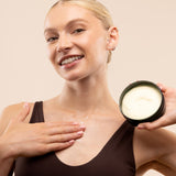 Woman applying Satsuma Body Butter 200 ML in professional studio setup against soft backdrop