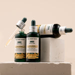 Three bottles of The Body Shop Ginger Scalp Serum 50 ML showcased on a neutral backdrop highlighting the brand's details.