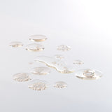 Artistic close-up showing droplets of ginger scalp serum on a clean surface, highlighting texture.
